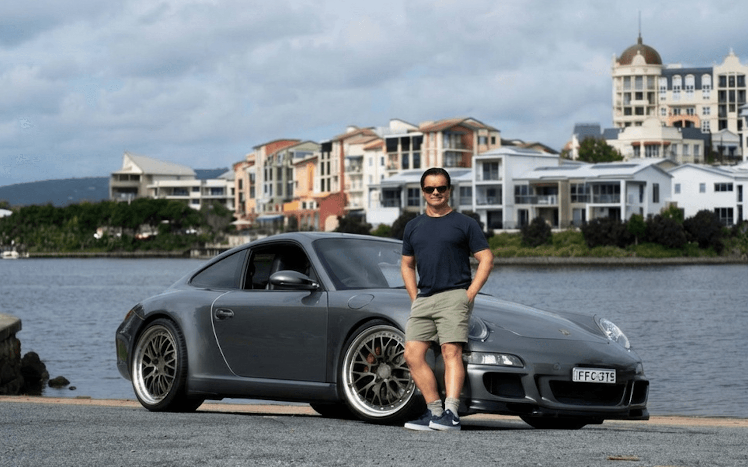 Greg Cassar, founder of The Collective, beside his Porsche on the Gold Coast waterfront